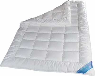 A white quilted duvet is shown laid out on a white background.