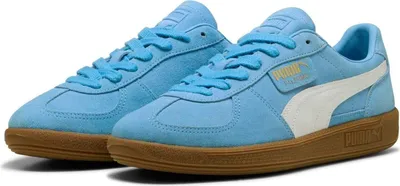 A pair of light blue Puma sneakers with white accents and a brown sole, displayed against a white background.