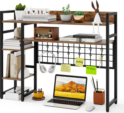 A desk shelf unit with various items on it, including a laptop, headphones, books, and decorative objects.