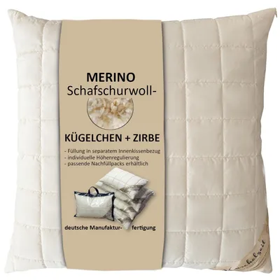 A cream-colored quilted pillow with a beige label detailing product information.