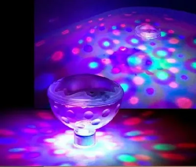 A submersible light show projector creating colorful patterns on a surface.
