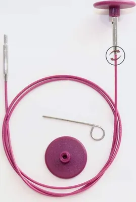 A knitting cable and accessories are laid out on a white background.