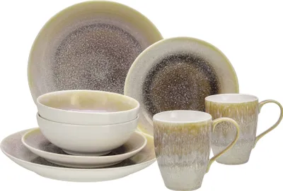 A set of stoneware dishes and mugs with a gradient glaze.