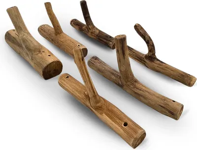 A set of six wooden coat hooks made from driftwood.