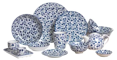 A collection of ceramic tableware with a blue floral pattern on a white background.