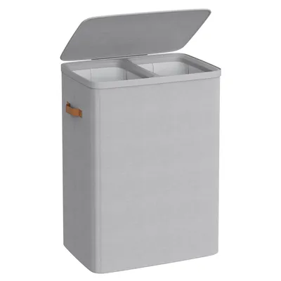 A light gray laundry basket with two compartments and a lid, shown from a slightly elevated front-left angle against a white background.