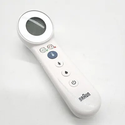 A white Braun digital thermometer is shown against a white background.
