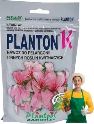 A bag of plant fertilizer with an illustration of pink flowers and a person holding a small potted plant.