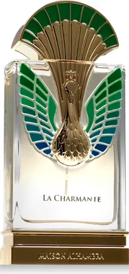 A close-up studio shot of a perfume bottle with ornate gold and colored detailing.