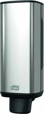 A Tork soap dispenser made of brushed stainless steel.