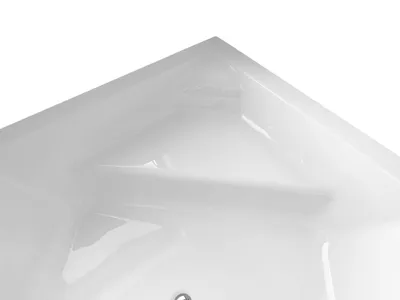 A close-up view of the corner of a white bathtub.