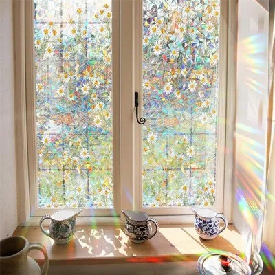 Productafbeelding van Unyqoos® Privacyfolie 43 x 100 cm – Uiterlijk van glas met een margrietmotief, zelfklevend, regenboogeffect, UV-bescherming tot 97% – Raamfolie voor huis en kantoor
