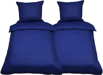 Two sets of dark blue bedding, each with a duvet and pillow, are displayed against a white background.