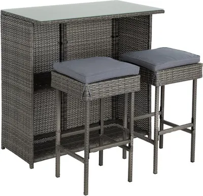 A polyrattan bar set with two stools and a glass tabletop.