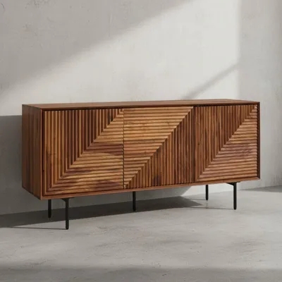A wooden sideboard with a geometric pattern on its doors, standing on black metal legs against a light gray and white wall.