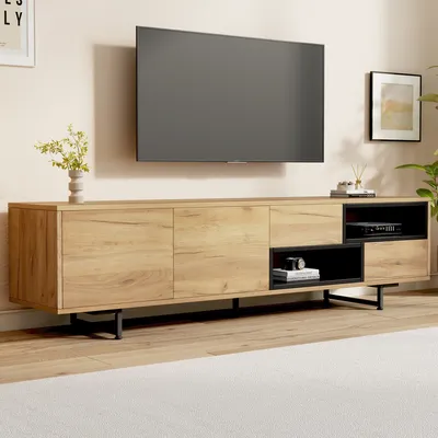 A modern living room with a TV mounted on the wall above a wooden TV stand.