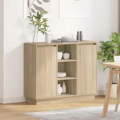 A wooden sideboard with doors and shelves, decorated with a vase of plants and some dishes.