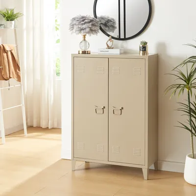 A camel-colored metal cabinet with two doors is shown in a room with a ladder shelf and a plant.