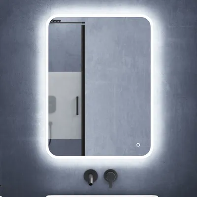 A modern bathroom mirror with integrated LED lighting, mounted on a textured gray wall above two faucets.