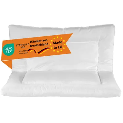 A white pillow with an orange banner overlay.