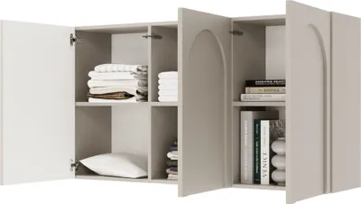 A close-up view of an open gray sideboard with white doors, revealing shelves with folded towels, a pillow, and books.