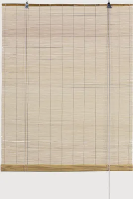 A bamboo roller blind hanging against a white background.