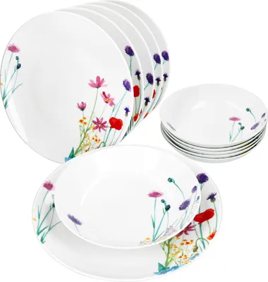A set of white porcelain plates and bowls decorated with a floral pattern.