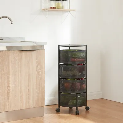 A black rolling cart with four mesh baskets filled with produce, placed next to a kitchen counter with a sink.