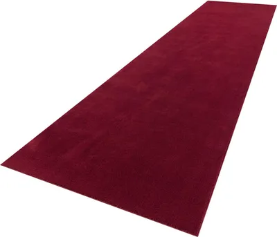 A red carpet runner is shown from a diagonal, slightly elevated perspective against a white background.