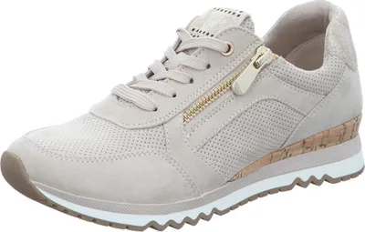 A single beige sneaker with a gold zipper detail is shown against a white background.
