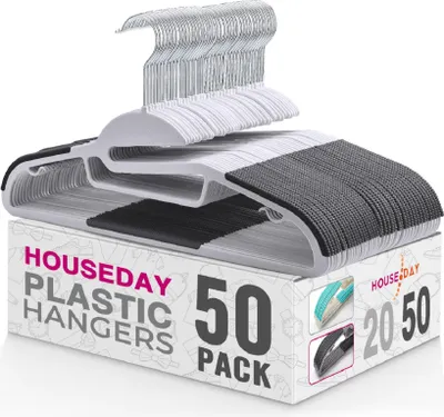 A stack of white plastic hangers with gray and black non-slip grips, neatly arranged on top of their packaging box.