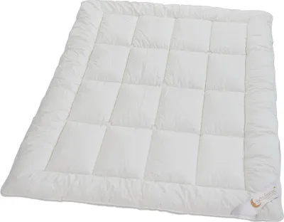 A white comforter is laid out flat on a white background.