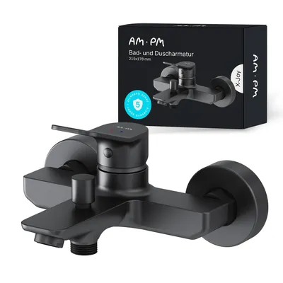 A black bathroom faucet is shown in front of its packaging.