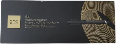 The image shows the packaging of a ghd Rise volumizing hot brush. The packaging is black with gold accents and features an illustration of the product and its name.