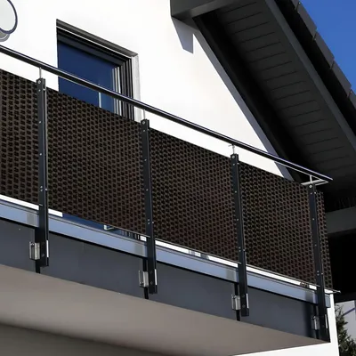 A balcony with a dark brown privacy screen attached to the railing.