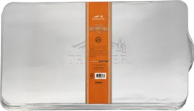 A stack of silver drip tray liners with an orange label in the center.