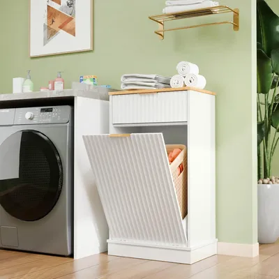 A laundry room with a washing machine and a white cabinet with a laundry basket.