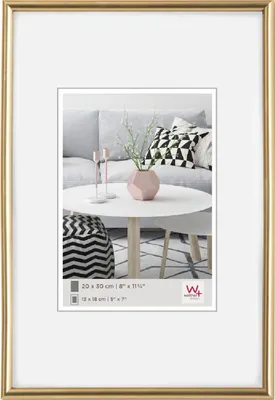 A framed picture of a living room scene with a sofa, coffee table, and decorative items.
