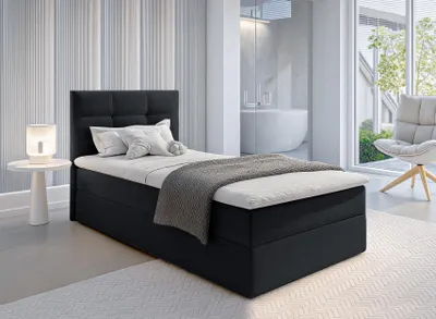 A bedroom scene with a bed, side table, and chair.