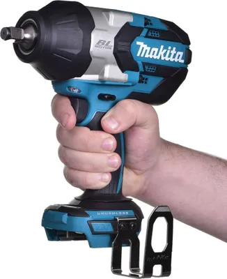 A hand holding a Makita cordless impact wrench.