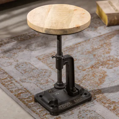 An industrial-style adjustable height side table with a wooden top and cast iron base.