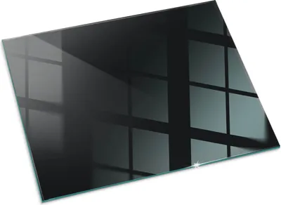 A dark gray glass hearth plate with reflections of a window grid.