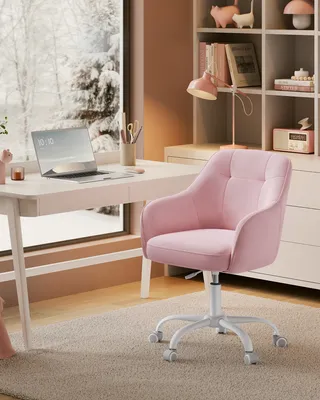 A pink office chair is placed next to a desk with a laptop and a window showing a snowy landscape.