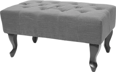 A gray tufted ottoman with dark wooden legs on a white background.