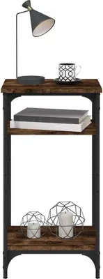 A narrow, three-tiered side table with a rustic wood finish and black metal frame, displayed against a white background. It is decorated with a lamp, a coffee cup, books, and two decorative candle holders with candles.