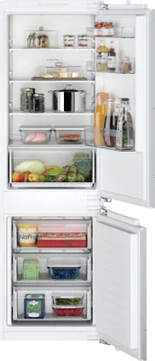 An open refrigerator with shelves stocked with food and drinks.