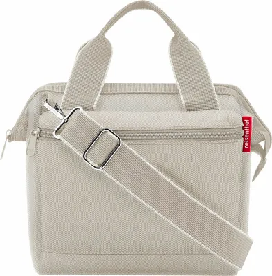 A beige reisenthel handbag with a shoulder strap is shown against a white background.