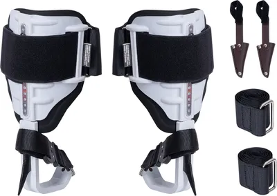A pair of white and black aluminum climbing spurs with straps and spike protectors, along with two additional straps, are displayed against a white background.
