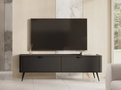 A modern living room setup featuring a TV stand with a television.
