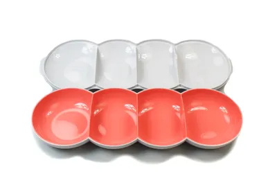 Two serving bowls, one white and one salmon colored, are shown side-by-side against a white background.